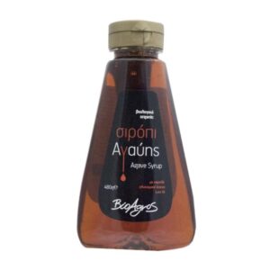 Agave syrup in a slightly inverted triangular plastic bottle with a gold cap and a black label